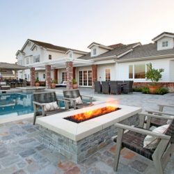 Seating area around custom raised stone veneer firepit - natural stone decking, Dreamscape by MGR leading pool contractor in Orange County
