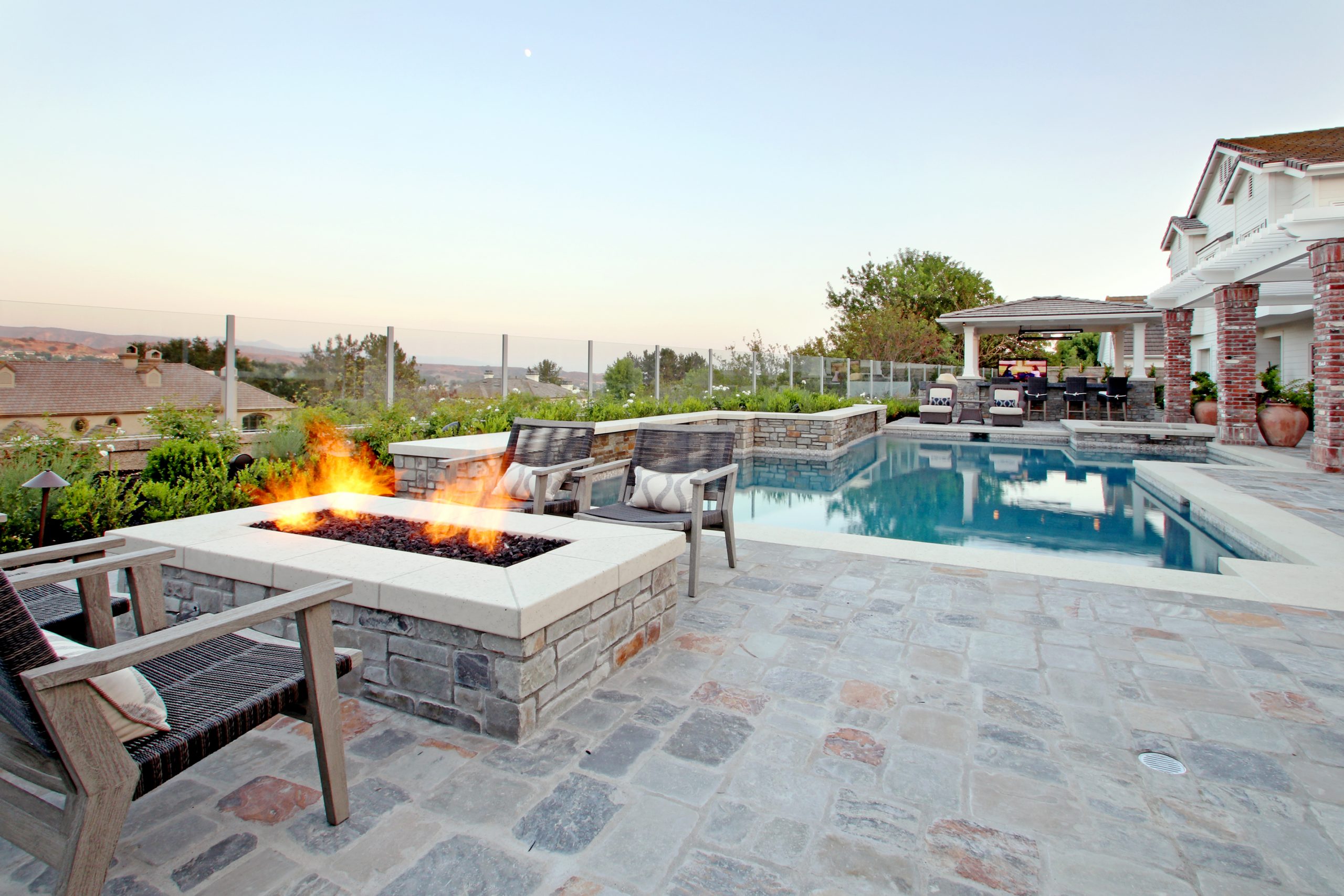 Spacious outdoor entertainment area, stone firepit, barbeque, Dreamscape by MGR leading pool contractor in Orange County