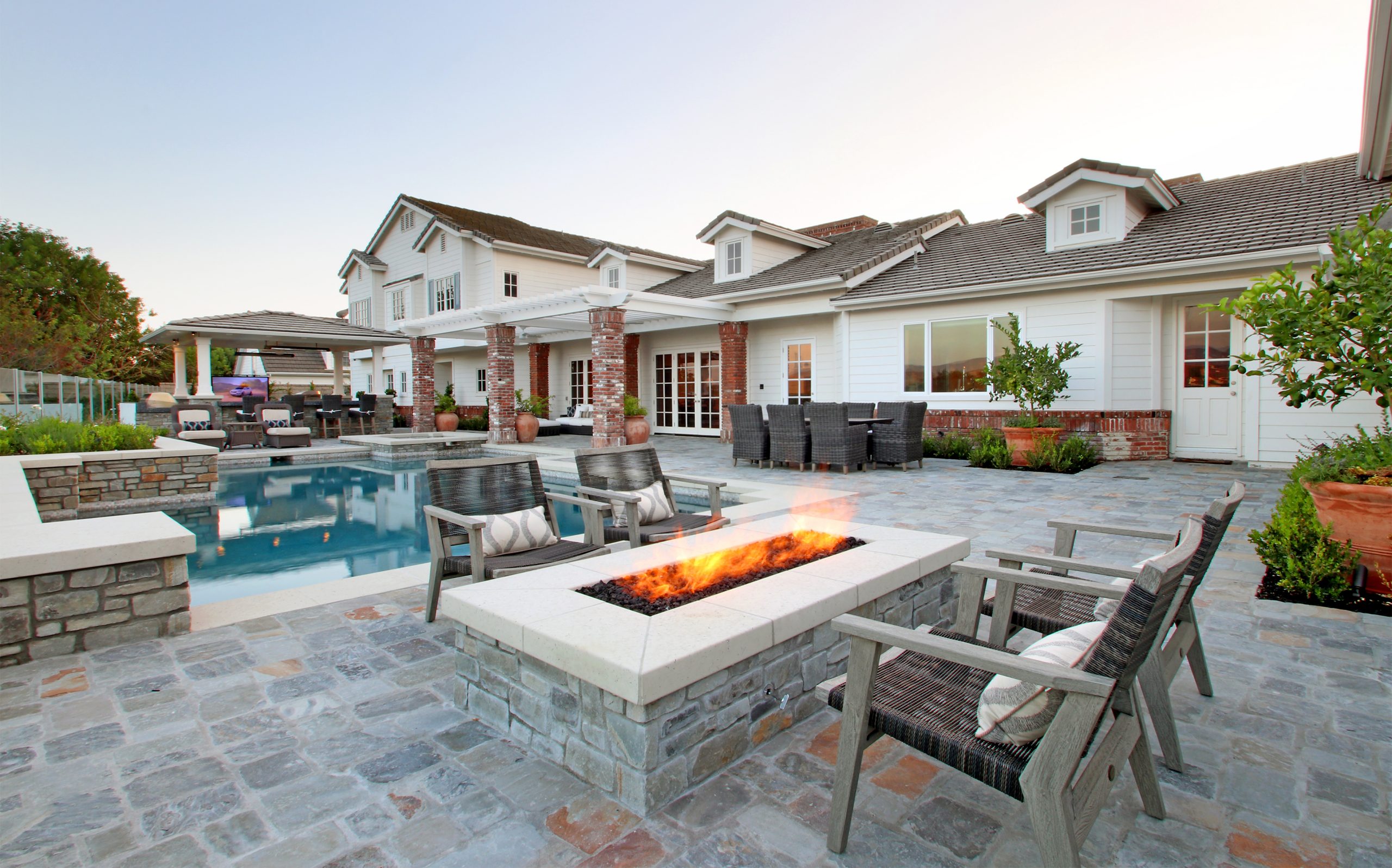 Large outdoor firepit and stone decking, Dreamscape by MGR leading pool contractor in Orange County