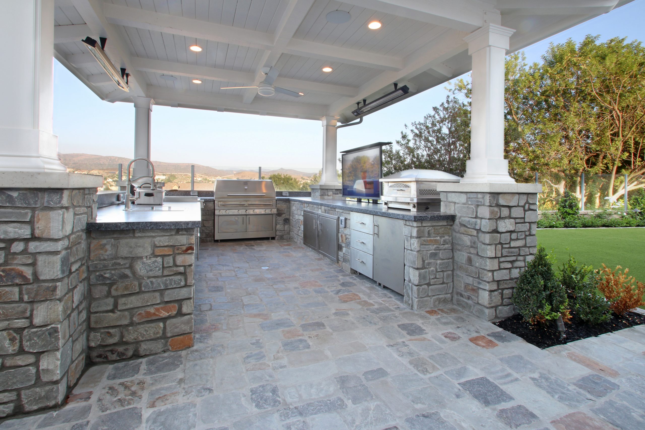 Outdoor loggia with natural stone veneer, Dreamscape by MGR leading pool contractor in Orange County
