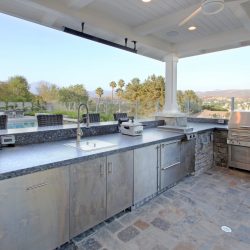 Natural stone deck and veneer, barbeque area under loggia, Dreamscape by MGR leading pool contractor in Orange County