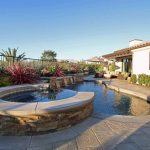 Elegant freeform pool and spa with stone hardscape, Dreamscape by MGR leading pool contractor in Orange County