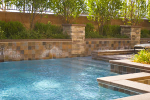 Stone tile veneer bond beam and custom pool, Dreamscape by MGR leading pool contractor in Orange County