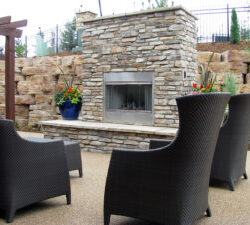 Stone veneer outdoor fireplace and sitting area, Dreamscape by MGR leading pool contractor in Orange County