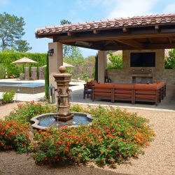 Tuscan theme landscape and pool, open loggia style with stone fireplace, design Dreamscapes by MGR leading pool contractor in Orange County